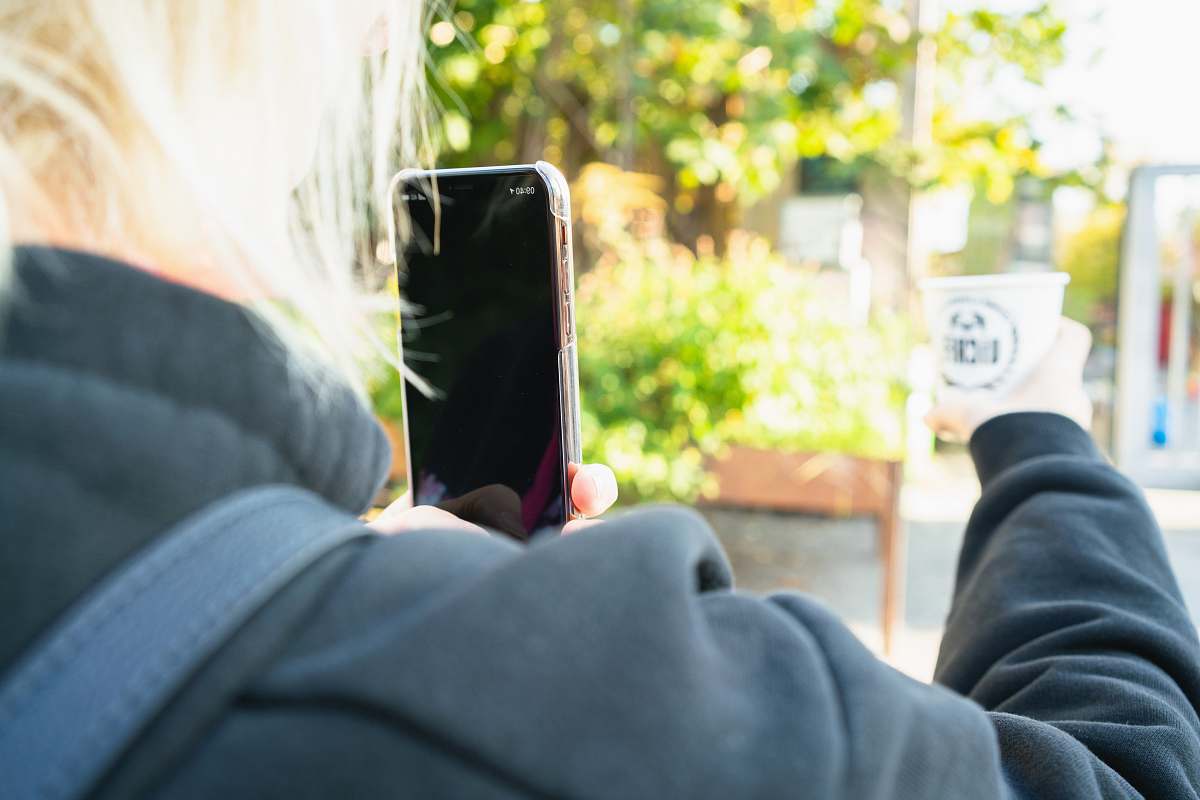 cell phone woman taking photo of white disposable cup mobile phone